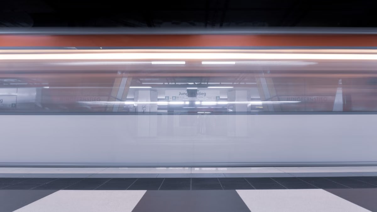 Dynamic shot of a subway train in motion at Jungfernstieg station, Hamburg.